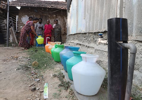 Residents of Uppiliyan Thittu lined up their empty pots to collect drinking water from a CCMC drinking water pipeline in Coimbatore on Tuesday.
