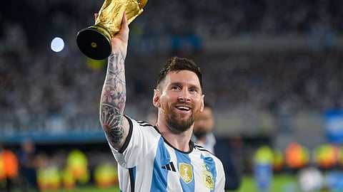 Argentina's Lionel Messi hoists the winning team replica of the FIFA World Cup trophy during a celebration ceremony for local fans after an international friendly football match against Panama at the Monumental stadium in Buenos Aires, Argentina, March 23, 2023.
