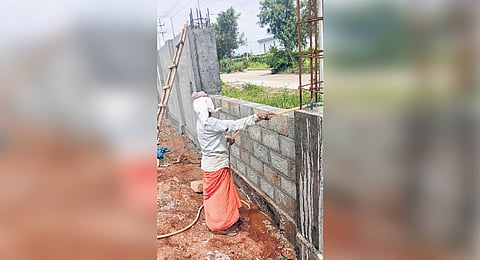 A compound wall being constructed at the land allotted for the Film City in Mysuru.
