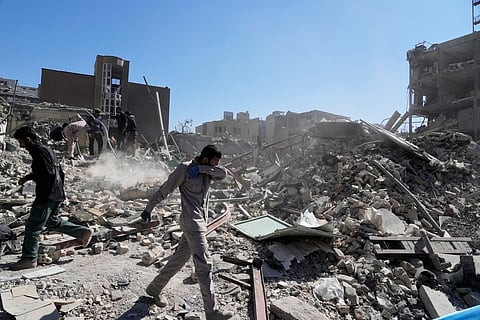 A group of men inspects the ruins of a police station struck Monday amid the US–Israeli military campaign in Tehran, Iran, Tuesday, March 3, 2026. 