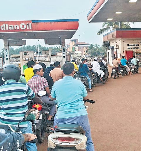 Motorists queue up in front of a petrol station in Gadag