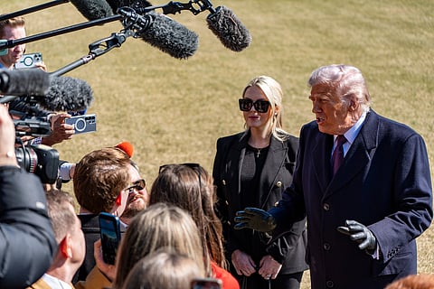 President Donald Trump, accompanied by White House press secretary Karoline Leavitt, speaks to reporters before departing on Marine One from the South Lawn of the White House, Friday, Feb. 27, 2026, in Washington.
