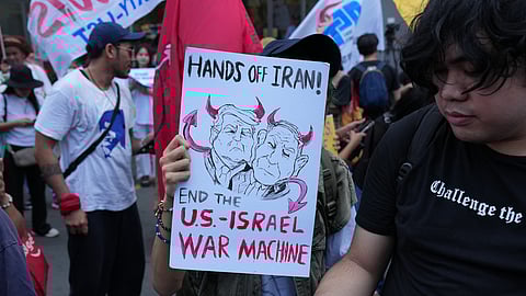 Protesters hold a caricature of US President Donald Trump and Israeli Prime Minister Benjamin Netanyahu during a rally in solidarity with Iran after they were blocked by police as they marched towards the US embassy in Manila, Philippines, on Tuesday, March 3, 2026. 