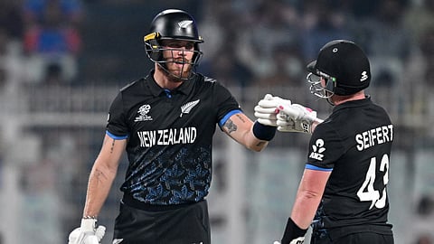 New Zealand's Finn Allen (L) and Tim Seifert bump their fists during the 2026 ICC Men's T20 Cricket World Cup semi-final match between New Zealand and South Africa at the Eden Gardens in Kolkata.