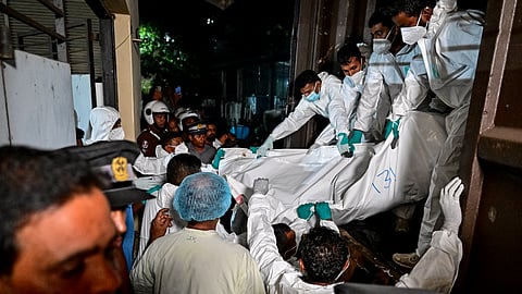 Healthcare workers carry the bodies of Iranian sailors who died in a US torpedo attack on their frigate IRIS Dena off Sri Lanka's southern coast, at the mortuary of the Karapitiya hospital in Galle on March 4, 2026.