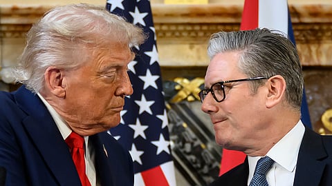 US President Donald Trump, left, and British Prime Minister Keir Starmer look at each other as they shake hands during a press conference at Chequers near Aylesbury, England, Thursday, Sept. 18, 2025.