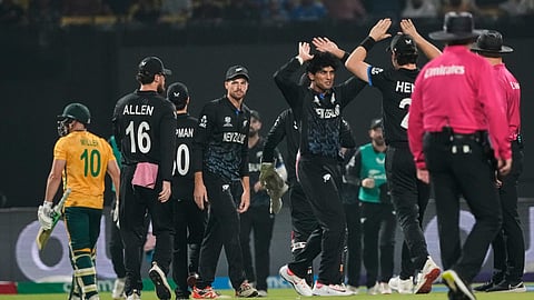 New Zealand's Rachin Ravindra celebrates the wicket of South Africa's David Miller, left, during the first T20 World Cup cricket semifinal match between New Zealand and South Africa in Kolkata, India, Wednesday, March 4, 2026.