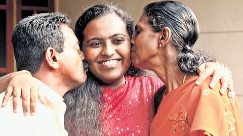 J S Sreeja of hiruvananthapuram, who secured the 57th rank, with her father M Jayakumar and mother K Sheeja on Friday.