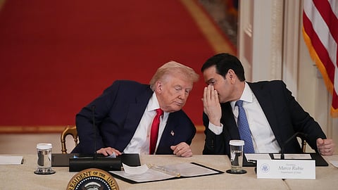 President Donald Trump speaks with Secretary of State Marco Rubio during a roundtable discussion on college sports in the East Room of the White House, Friday, March 6, 2026, in Washington.