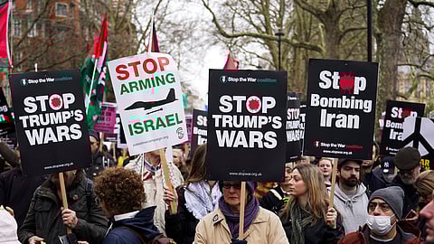 Demonstrators hold flags and placards as they attend a Stop the War Coalition march in London, Saturday, March 7, 2026.
