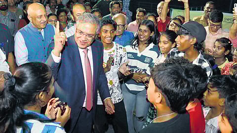 Chief Election Commissioner Gyanesh Kumar interacting with  children during a visit to Marine Drive in Kochi on Friday.