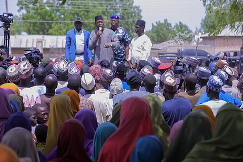People listen to Babagana Zulum, the Borno state governor, in Pulka, Nigeria, Friday, March 6, 2026, after they fled an attack by Islamic militants in Ngoshe
