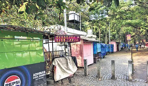 Stalls set up on the footpath in front of a park in Fort Kochi.