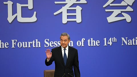Chinese Foreign Minister Wang Yi arrives for a press conference on the sideline of the National People's Congress (NPC) at the media centre in Beijing, Sunday, March 8, 2026.