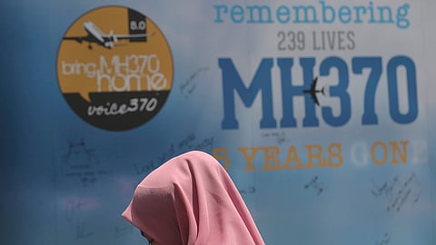 A girl stands in front of a condolence message board during a Day of Remembrance for the MH370 event in Kuala Lumpur, Malaysia, on March 3, 2019.