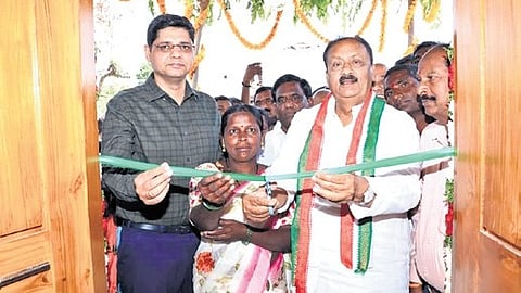 One of the beneficiaries cuts the ribbon during the housewarming ceremony in Chinnamalla Reddy on Saturday.