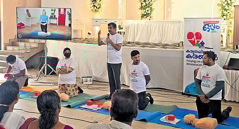 Volunteers during a CPR training session in Alangad.