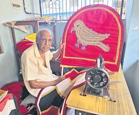 Achutha Warrier with an old temple flag crafted by him