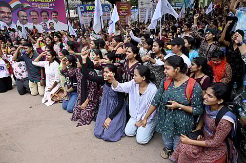 Nurses kneel in protest at UNA-led demonstration at Kozhikode Collectorate, demanding basic pay hike.