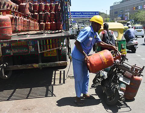 A delivery person taking cylinders for deliver from Vatal Nagaraj Road (near Lulu Mall) in Bengaluru on March 10, 2026.