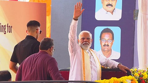 Prime Minister Narendra Modi greets party workers in front of Jawaharlal Nehru International Stadium after arriving in the city for programmes including the official launch of the National Democratic Alliance (NDA) Assembly election campaign.