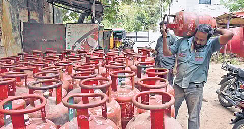 Workers loading LPG cylinders.