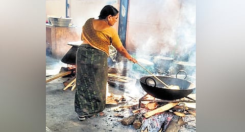 Cooks at Osmania University hostel use firewood to conserve LPG stocks in Hyderabad on Wednesday. 
