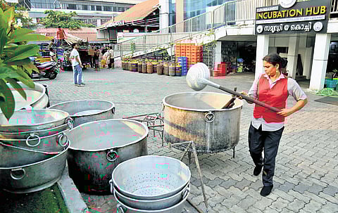 A staffer of a Samridhi outlet setting up firewood stoves to prepare food as commercial LPG cylinder shortage cripples eateries in the city.