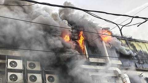 Flames and smoke billow after a fire broke out at a company building, in Noida, Uttar Pradesh, Thursday, March 12, 2026.