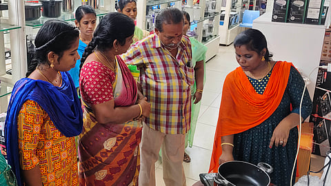 People checking out an induction stove at a store  in Madurai on Thursday 