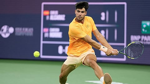Carlos Alcaraz, of Spain, returns a shot against Cameron Norrie, of Britain, during a quarterfinal match at the BNP Paribas Open tennis tournament, Thursday, March 12, 2026, in Indian Wells, Calif.