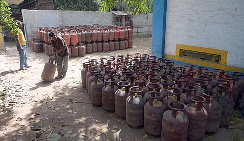 A worker moves an LPG cylinder amid shortage of LPG supply, in New Delhi on Thursday.