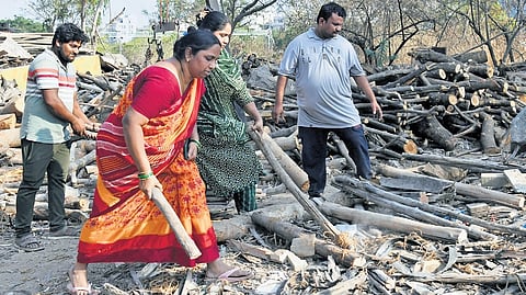 Amidst a reported shortage of LPG cylinders, women pick firewood at a timber depot in Hafeezpet, Hyderabad, on Thursday.