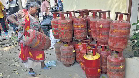 An elderly woman makes her way to a gas company office to take a refill in Vijayawada on Thursday.