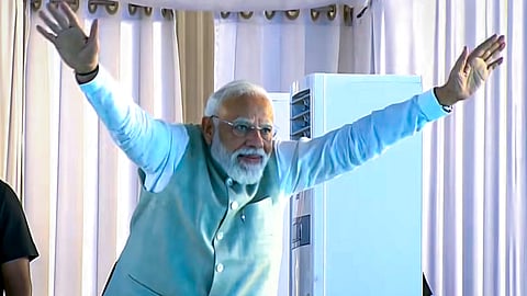 In this screengrab from a video posted on March 14, 2026, Prime Minister Narendra Modi greets during the foundation stone laying and unveiling ceremony of various development works, in Silchar, Assam.