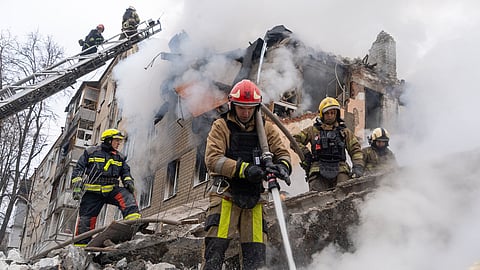 In this photo from March 7, 2026, firefighters put out the fire in the ruins of an apartment building following Russia's missile attack in Kharkiv, Ukraine.