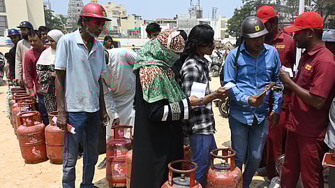 People lined up to take domestic LPG gas cylinders at Shivajinagar in Bengaluru on Friday.