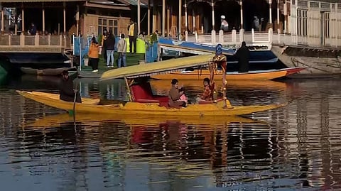 Summer tourists enjoy a chilly morning at Dal Lake in Srinagar.