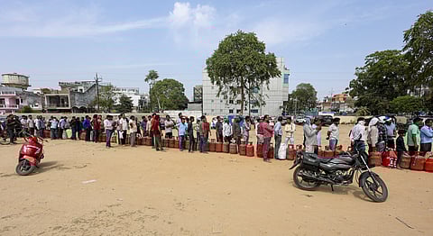 People wait in a queue to collect LPG cylinders amid the ongoing fuel shortages, in Vikas Nagar area, Lucknow, Saturday, March 14, 2026. 