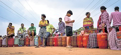 People from Salia Sahi slum waiting in queue to get LPG cylinders in Bhubaneswar.