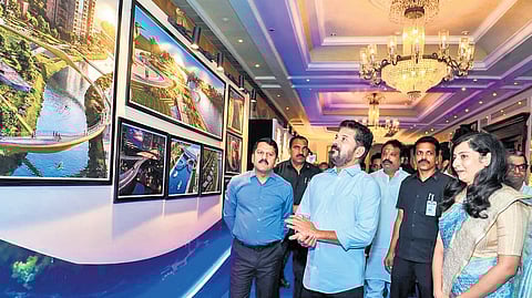 Chief Minister A Revanth Reddy goes around the photo gallery on Musi river project at a hotel in Hyderabad on Friday.