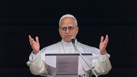 Pope Leo XIV appears at the window of his studio overlooking St. Peter's Square at the Vatican where Catholic faithful and pilgrims gathered for the traditional Sunday blessing at the end of the noon Angelus prayer, Sunday, March 15, 2026. 