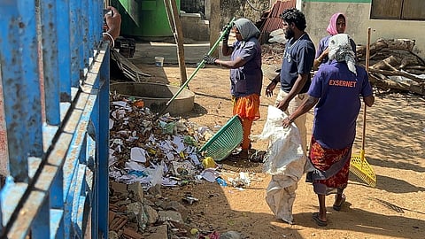 Sanitation workers clearing off the waste piled up inside the government high school in Rameswaram on Saturday.