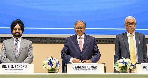 Chief Election Commissioner Gyanesh Kumar, centre, with Election Commissioners S S Sandhu, left, and Vivek Joshi during a press conference to announce the Assembly election schedule for West Bengal, Tamil Nadu, Kerala, Assam and Puducherry, at Vigyan Bhawan in New Delhi, Sunday, March 15, 2026.