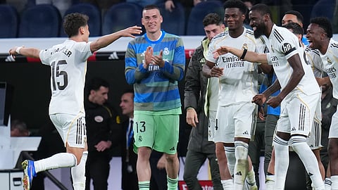 Real Madrid's Arda Guler, left, celebrates after scoring his side's fourth goal during a Spanish La Liga soccer match between Real Madrid and Elche CF, in Madrid, Saturday, March 14, 2026. 