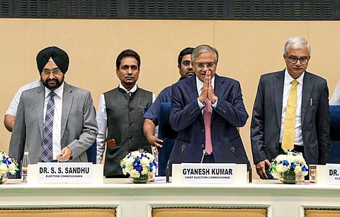 New Delhi: Chief Election Commissioner Gyanesh Kumar, centre, with Election Commissioners S S Sandhu, left, and Vivek Joshi, right, during a press conference, at Vigyan Bhawan in New Delhi, Sunday, March 15, 2026. 