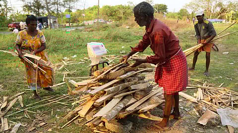 Workers weighing wood scraps for sale. 