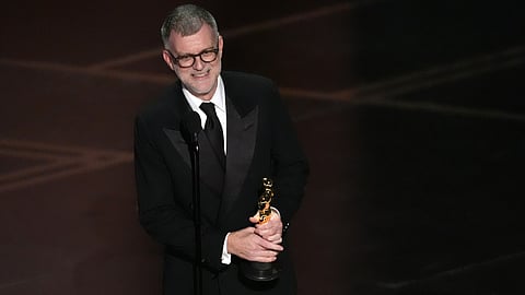 Paul Thomas Anderson accepts the award for directing for "One Battle After Another" during the Oscars on Sunday, March 15, 2026, at the Dolby Theatre in Los Angeles. 