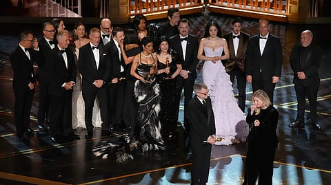Paul Thomas Anderson, left center, Sara Murphy, right center, and the team from "One Battle After Another" accept the award for best picture during the Oscars on Sunday, March 15, 2026, at the Dolby Theatre in Los Angeles.