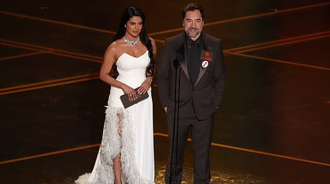 Priyanka Chopra Jonas, left, and Javier Bardem present the award for best international feature film during the Oscars on Sunday, March 15, 2026, at the Dolby Theatre in Los Angeles. 
